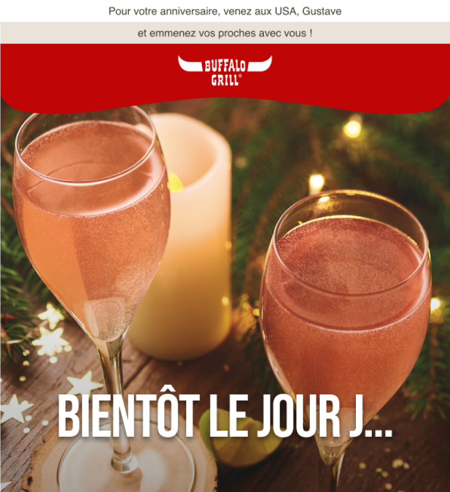 Bannière email teaser anniversaire Buffalo Grill, composition festive avec verres de vin pétillant et bougies, direction artistique axée sur l'expérience client.